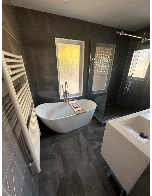 Luxury bathroom with freestanding tub and heated towel rail
